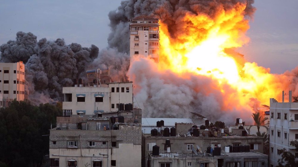 Fresh Israeli air strikes hit two residential buildings in besieged Gaza