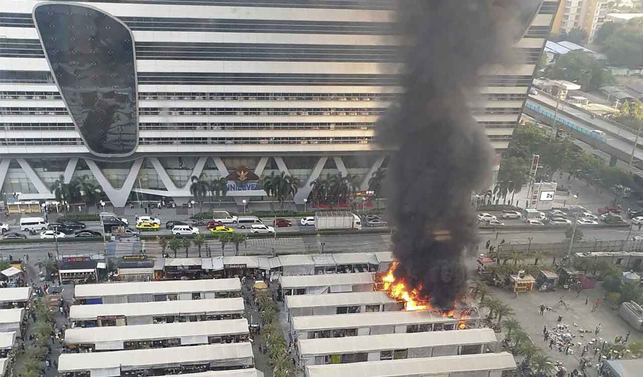 Fire at a popular open market in Bangkok spews black smoke visible for miles