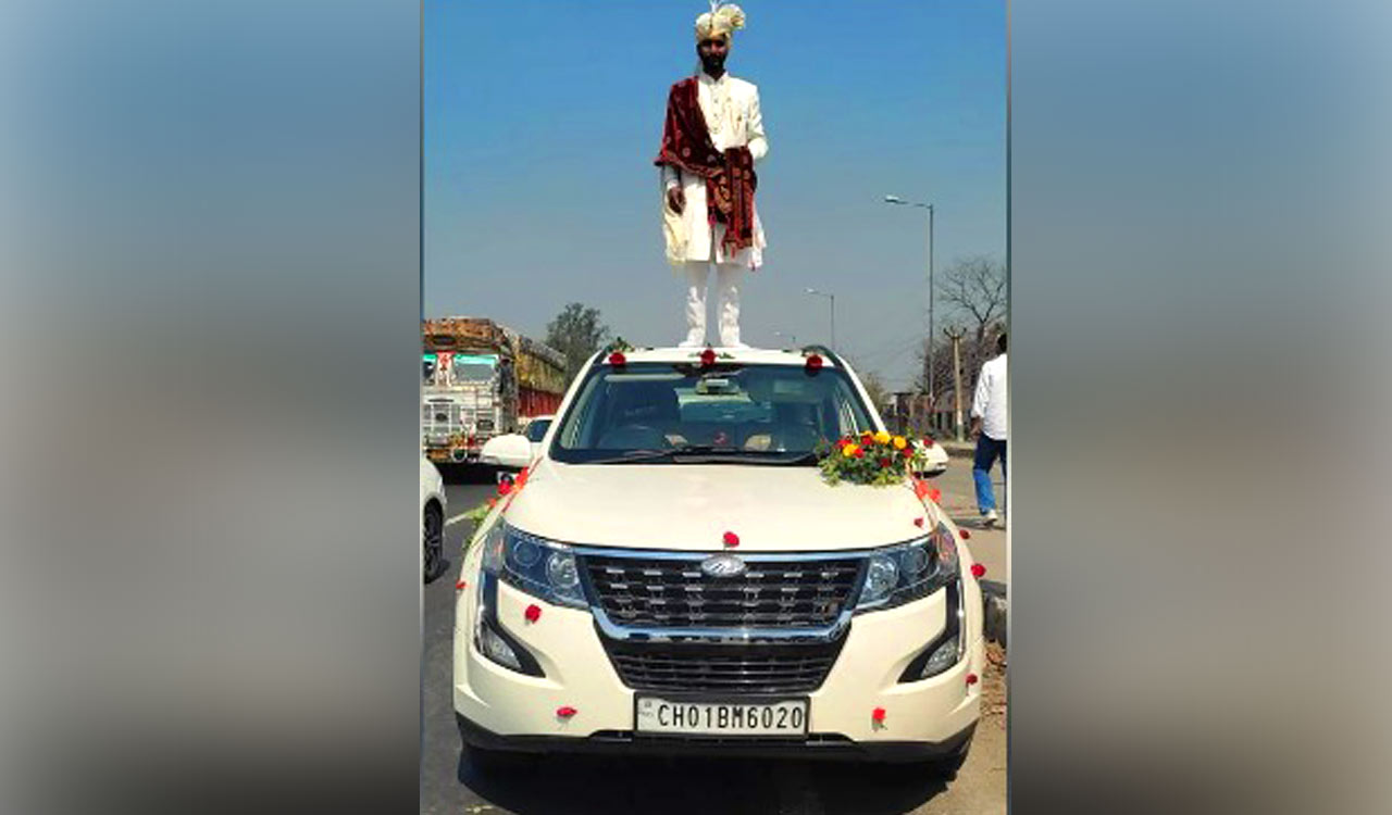 Police seize SUV after viral photo shows groom on top of car