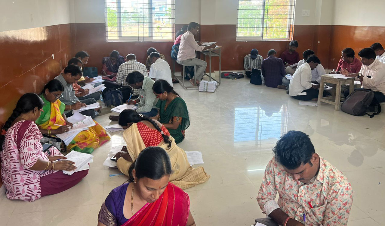 Evaluators forced to sit on floor at Telangana exam camps