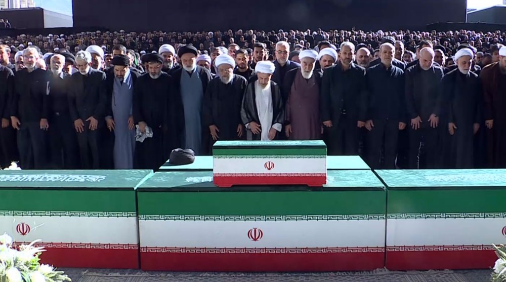 Mourners perform funeral prayers for martyred Leader
