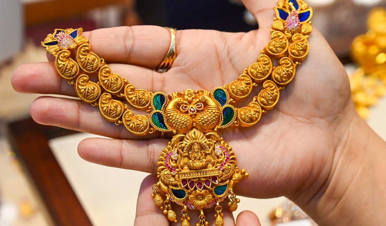 Gold trades flat, silver slips in early trade as crude oil prices ease